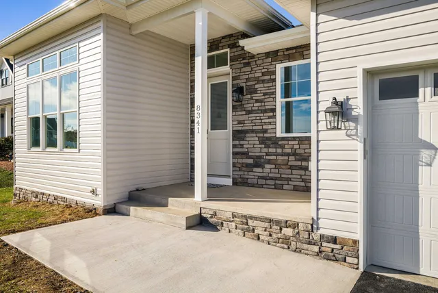 a kitchen with a stove and white cabinets