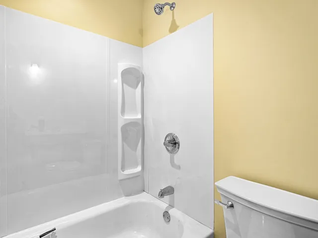 a bathroom with a bathtub and a toilet