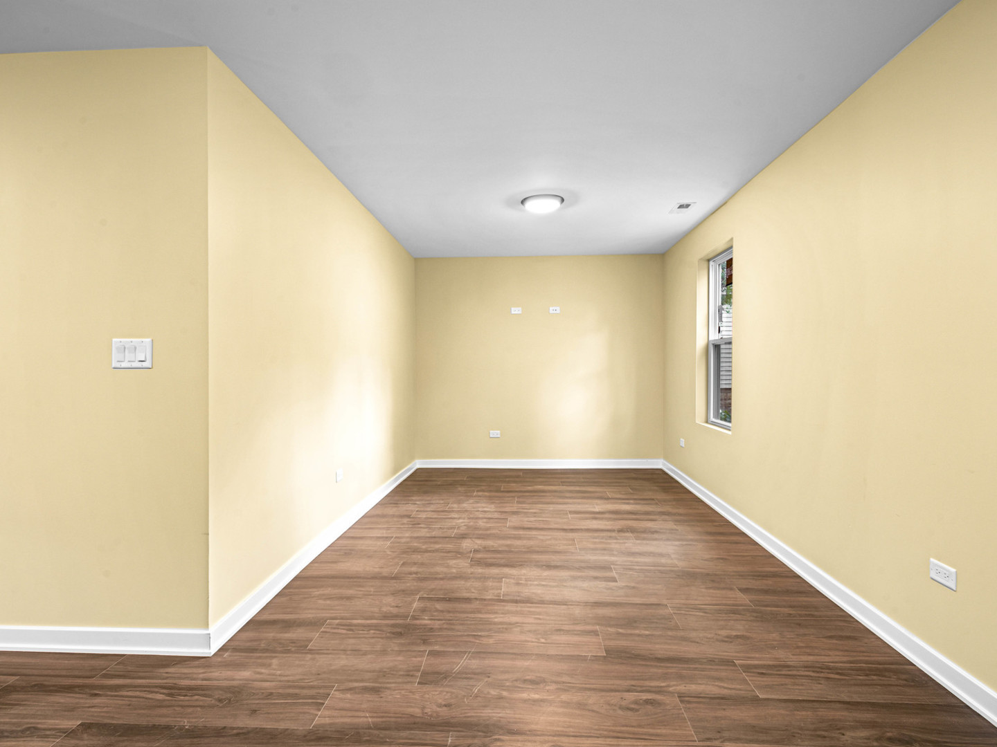 422 Sherman Street Joliet, IL 60433 - Photo 14 of 20 a view of a big room with wooden floor and windows