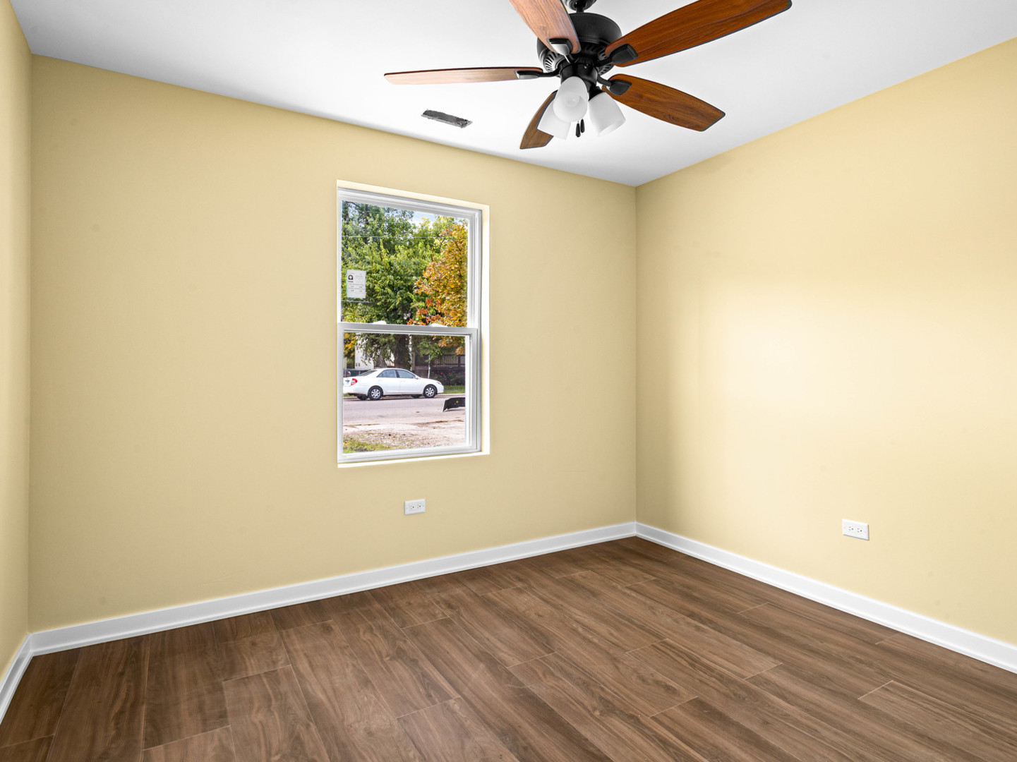422 Sherman Street Joliet, IL 60433 - Photo 18 of 20 a view of an empty room with wooden floor and a window
