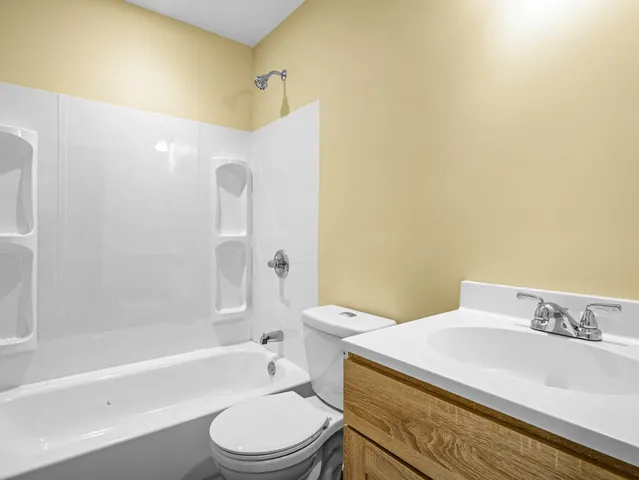 a bathroom with a sink a toilet and bathtub