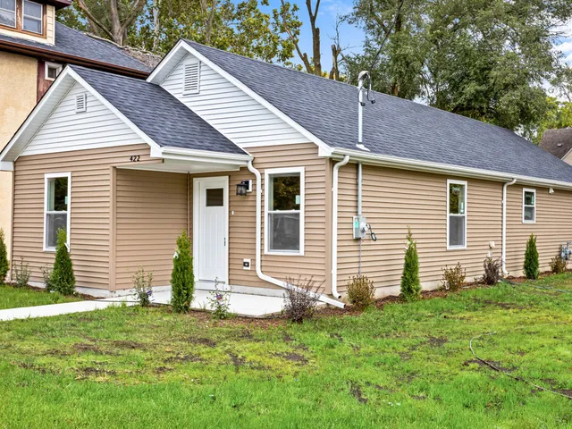 a front view of a house with a yard