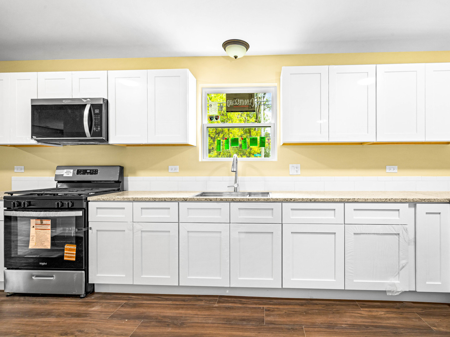 422 Sherman Street Joliet, IL 60433 - Photo 6 of 20 a kitchen with stainless steel appliances white cabinets and a sink