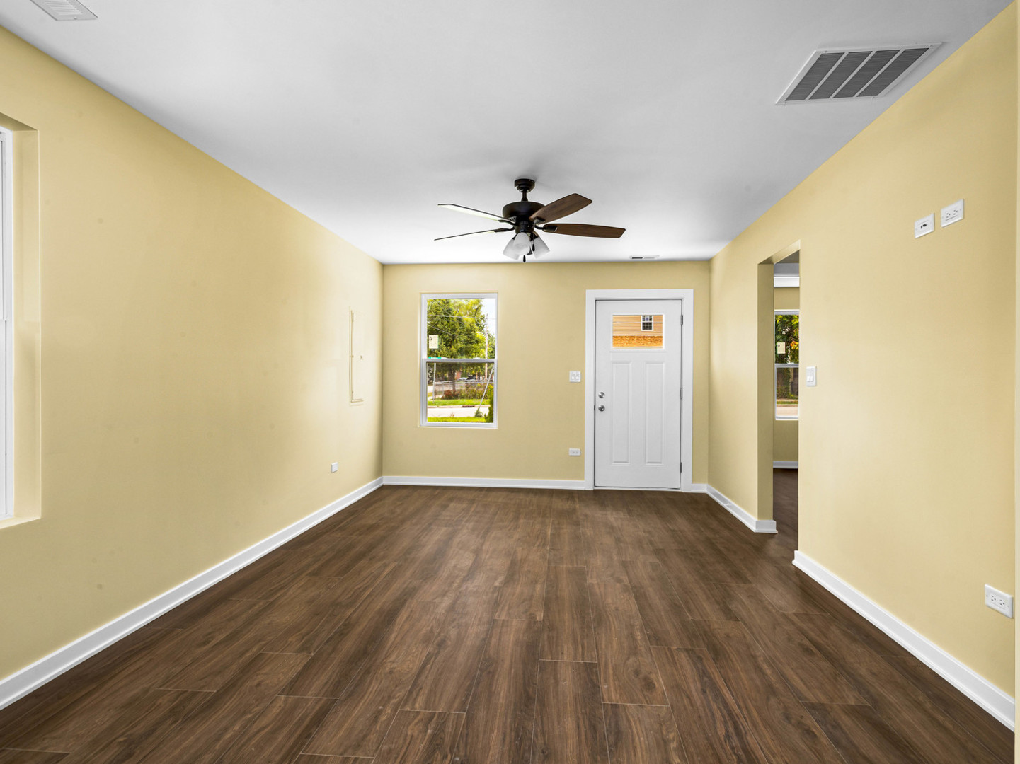 422 Sherman Street Joliet, IL 60433 - Photo 9 of 20 an empty room with wooden floor and windows