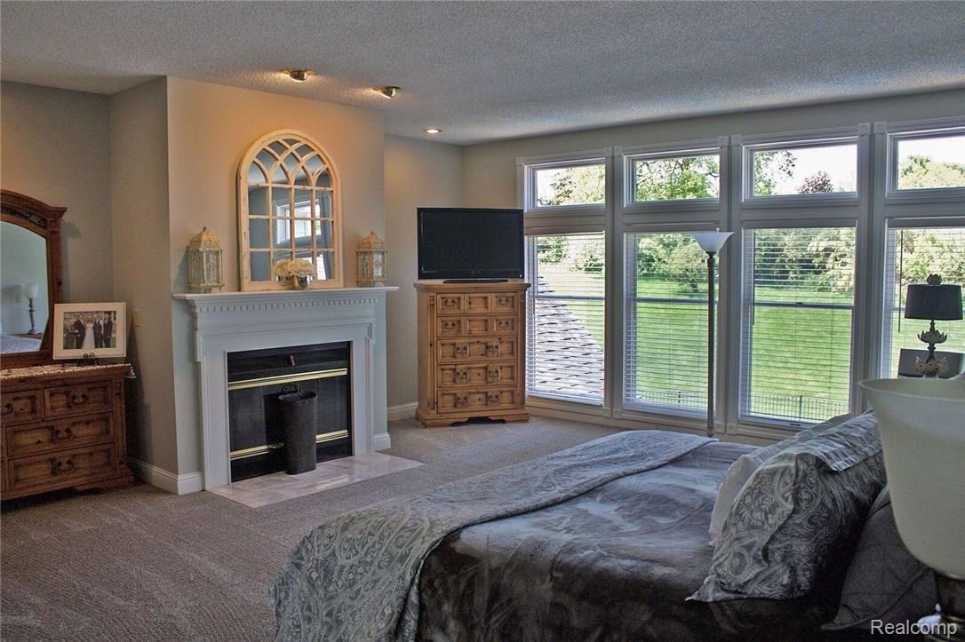8096 Chilson Road Pinckney, MI 48169 - Photo 20 of 46 Huge Master Bedroom with Fireplace and Pool View!