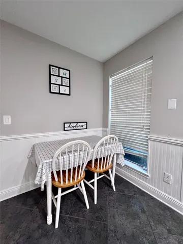 a kitchen with kitchen island granite countertop a sink stove and refrigerator