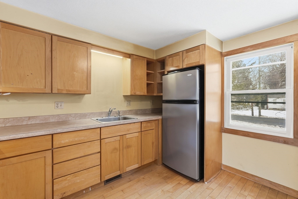 105 Pomeroy Lane Amherst, MA 01002 - Photo 15 of 40 a kitchen with stainless steel appliances granite countertop a refrigerator and a sink
