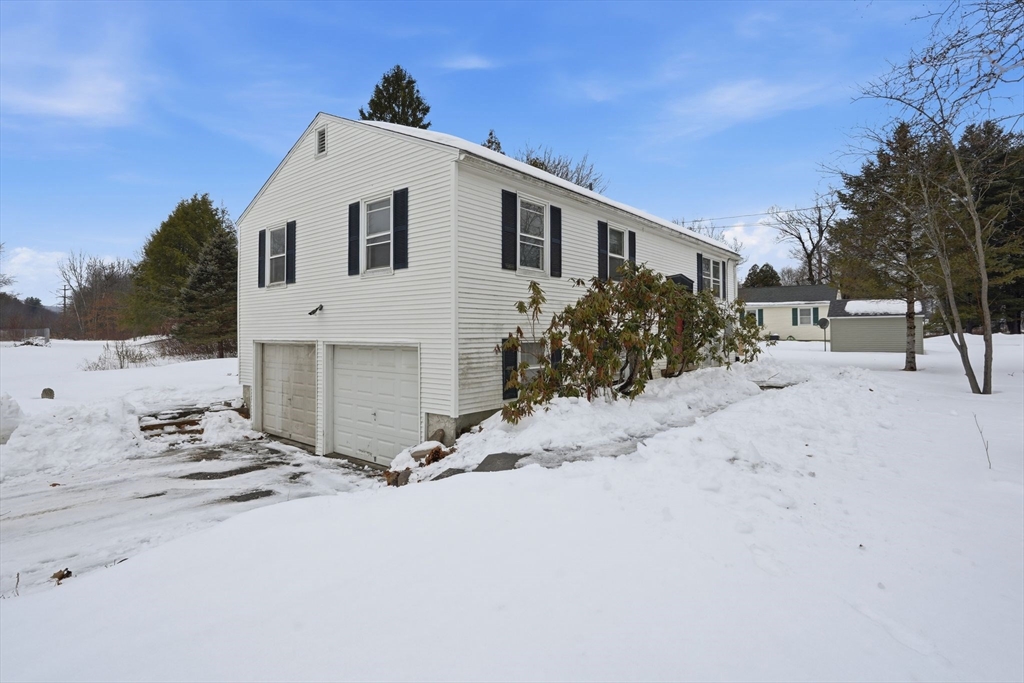105 Pomeroy Lane Amherst, MA 01002 - Photo 2 of 40 a view of a white house with a snow in the background