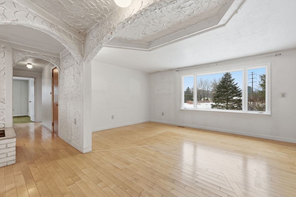 105 Pomeroy Lane Amherst, MA 01002 - Photo 9 of 40 wooden floor in an empty room with a window