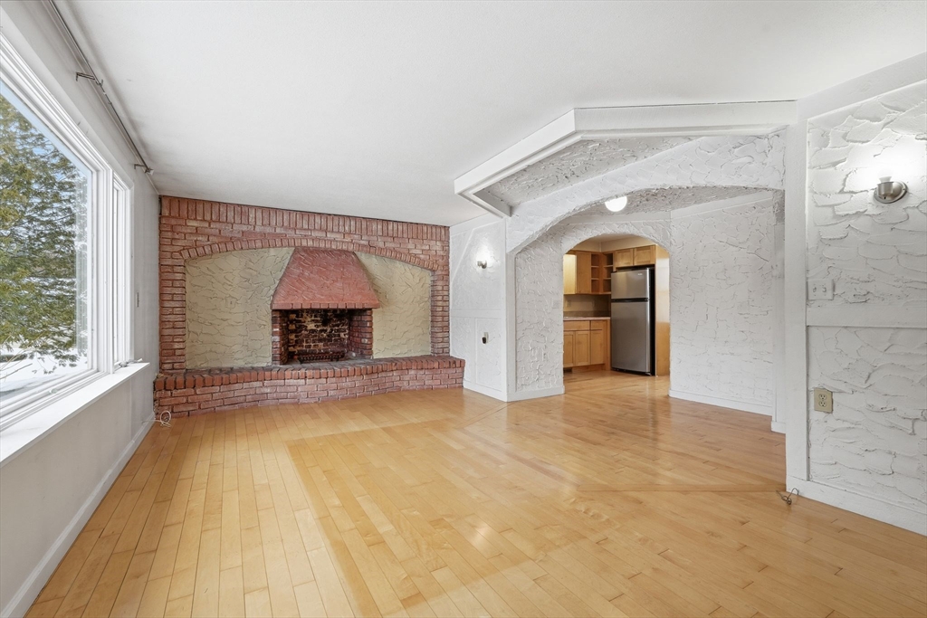 105 Pomeroy Lane Amherst, MA 01002 - Photo 10 of 40 an empty room with fireplace and windows
