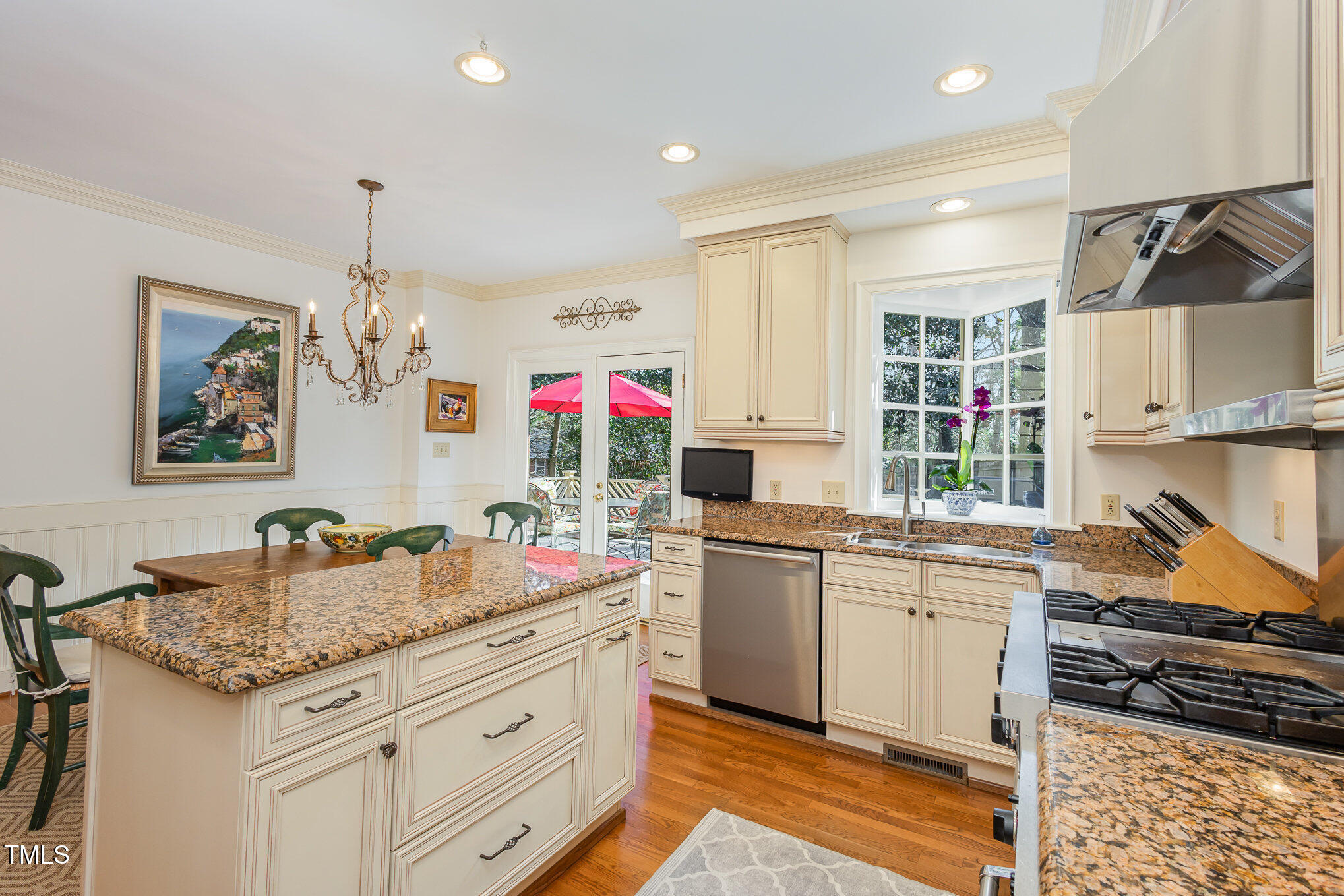 1420 Dogwood Lane Raleigh, NC 27607 - Photo 13 of 37 a kitchen that has a lot of cabinets in it and wooden floors