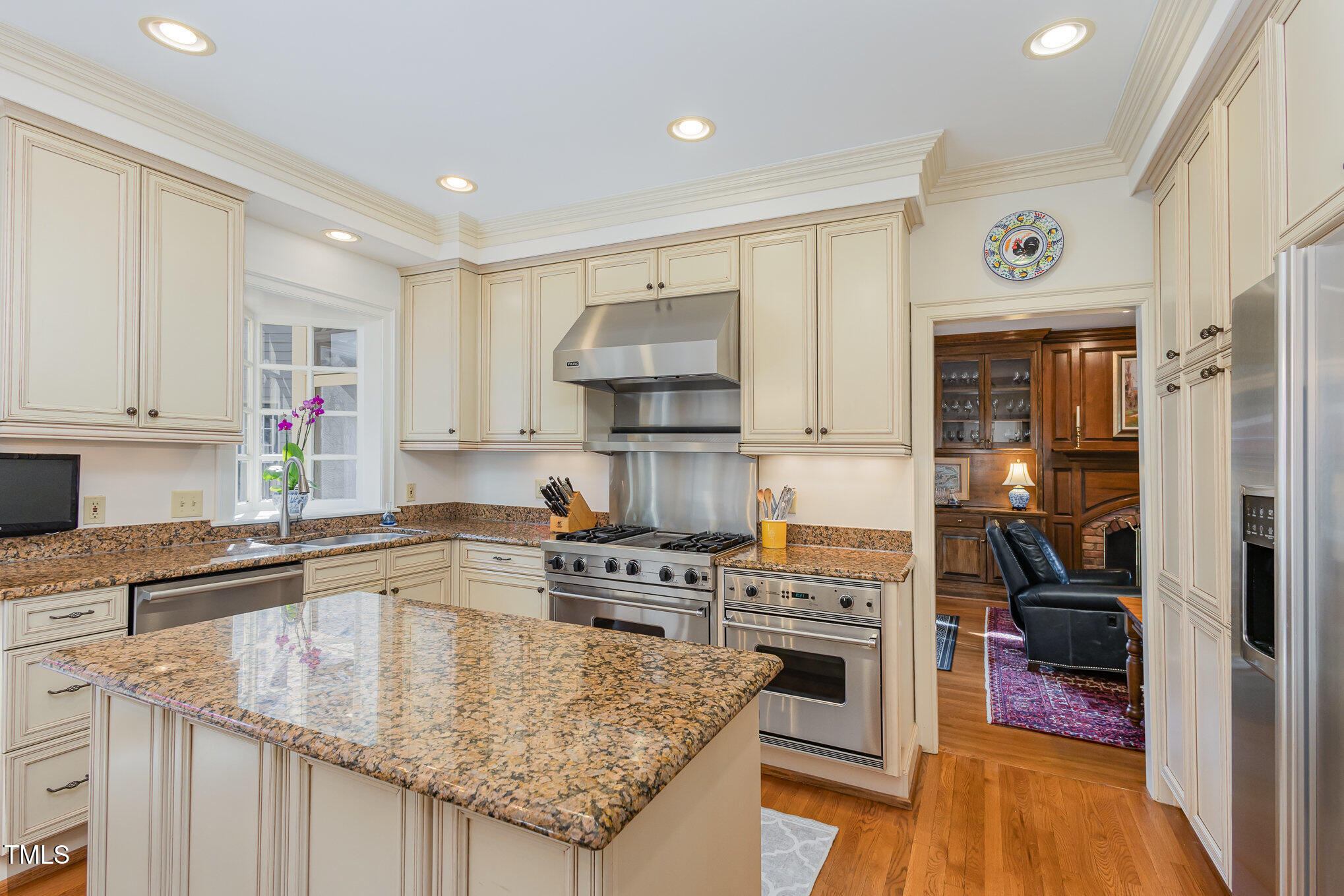 1420 Dogwood Lane Raleigh, NC 27607 - Photo 14 of 37 a kitchen with kitchen island granite countertop a stove sink and cabinets