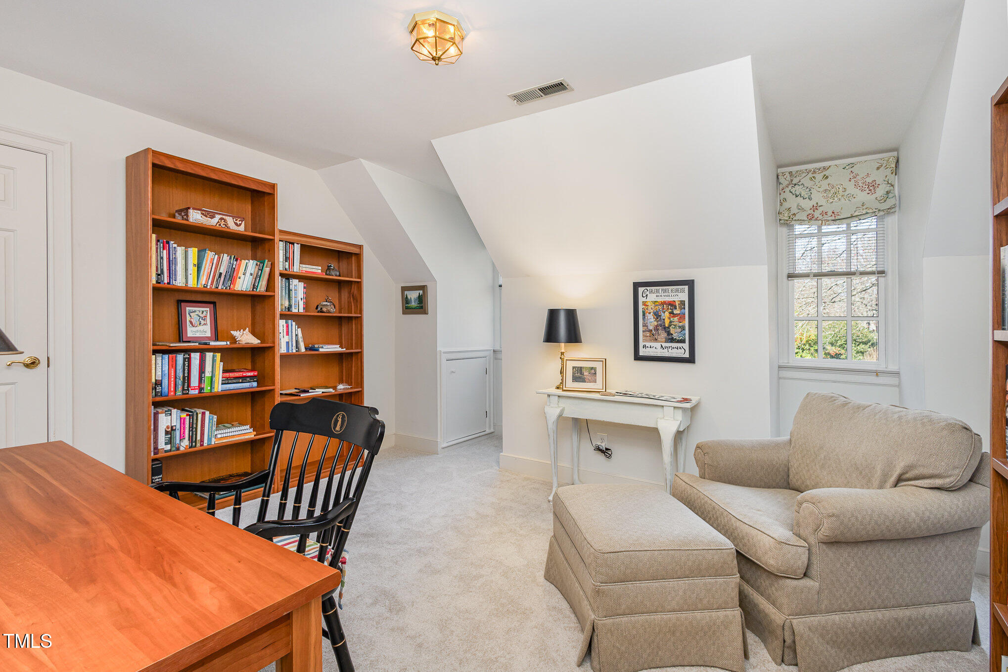 1420 Dogwood Lane Raleigh, NC 27607 - Photo 16 of 37 a living room with furniture a baby crib and a window