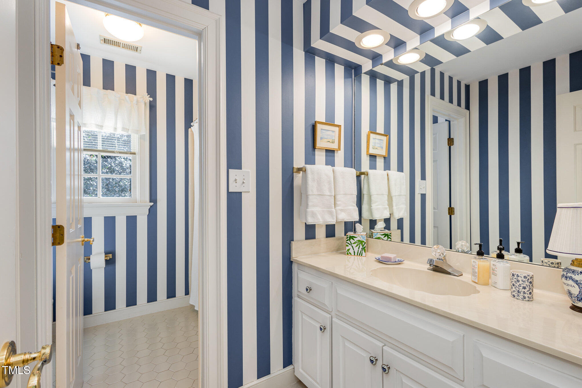 1420 Dogwood Lane Raleigh, NC 27607 - Photo 26 of 37 a bathroom with a double vanity sink and a mirror
