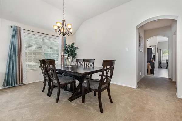 a view of a dining room with furniture and chandelier