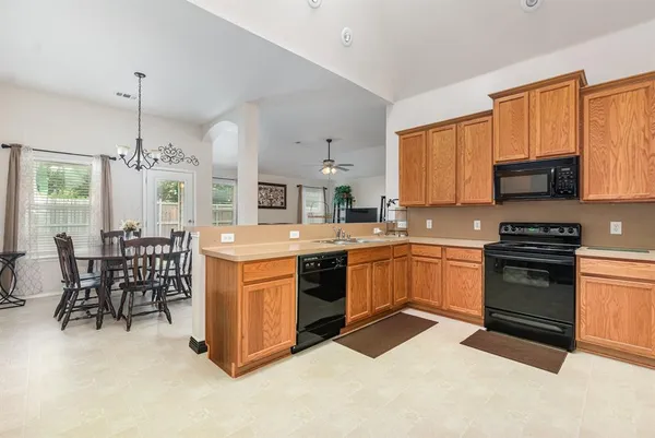 a kitchen with a stove a sink and a refrigerator