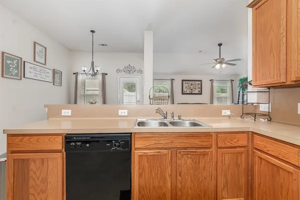 a bathroom with a granite countertop sink a mirror and cabinets