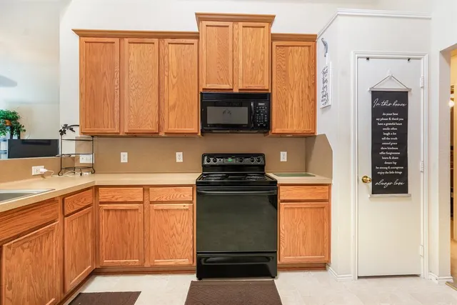 a kitchen with stainless steel appliances granite countertop a stove and a microwave
