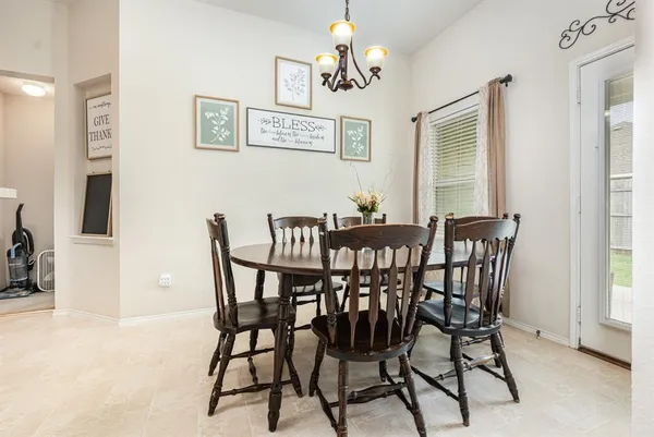 a view of a dining room with furniture and a chandelier