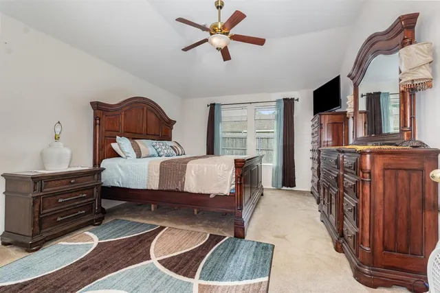 a bedroom with a bed dresser and a window