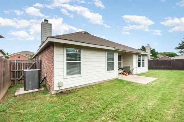 a view of a house with a yard and deck