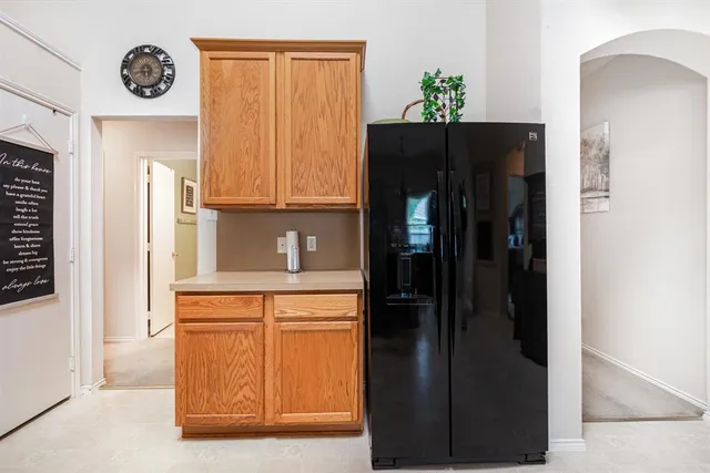 a kitchen with a refrigerator and a stove