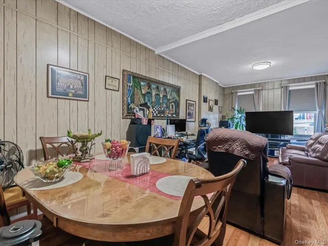 a living room with furniture a flat screen tv and a large window