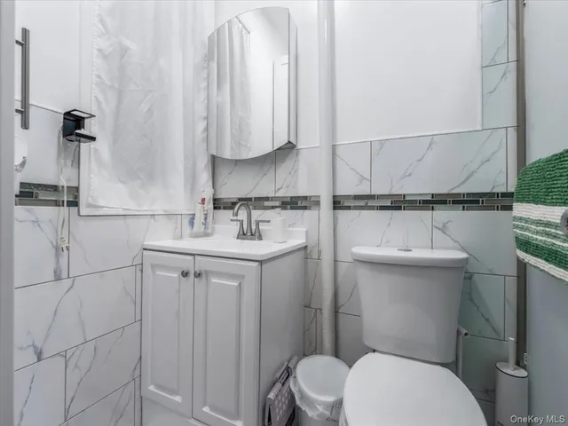 a bathroom with a sink a toilet and mirror