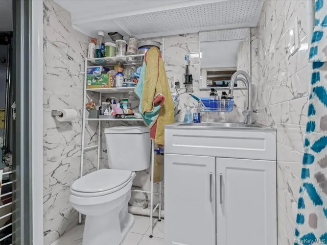 a bathroom with a sink toilet vanity and shower