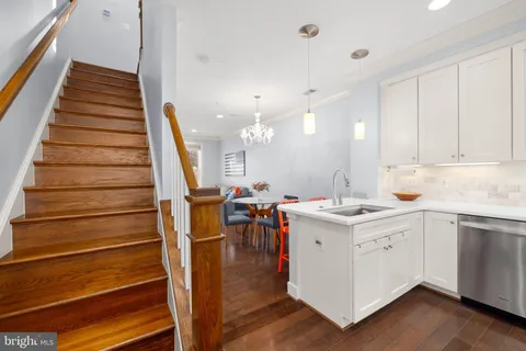 a kitchen with a sink cabinets and stainless steel appliances