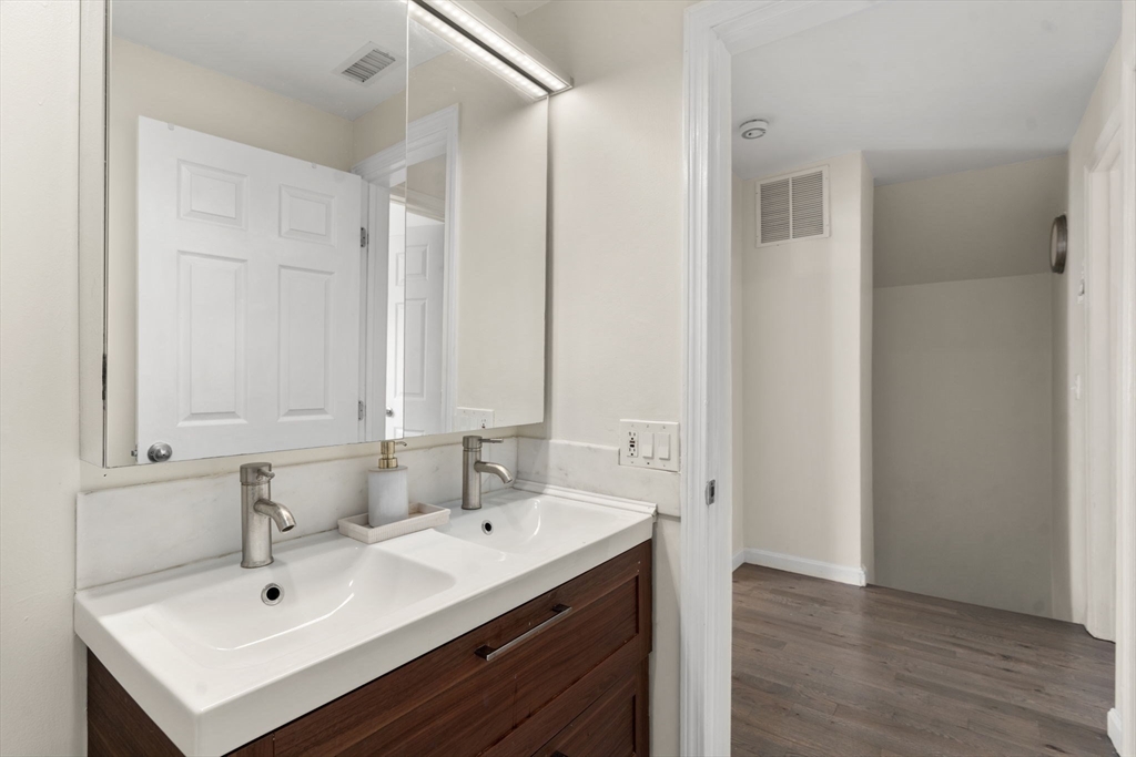 9 Marshall Street Winthrop, MA 02152 - Photo 11 of 34 a view of bathroom with sink mirror and wooden floor