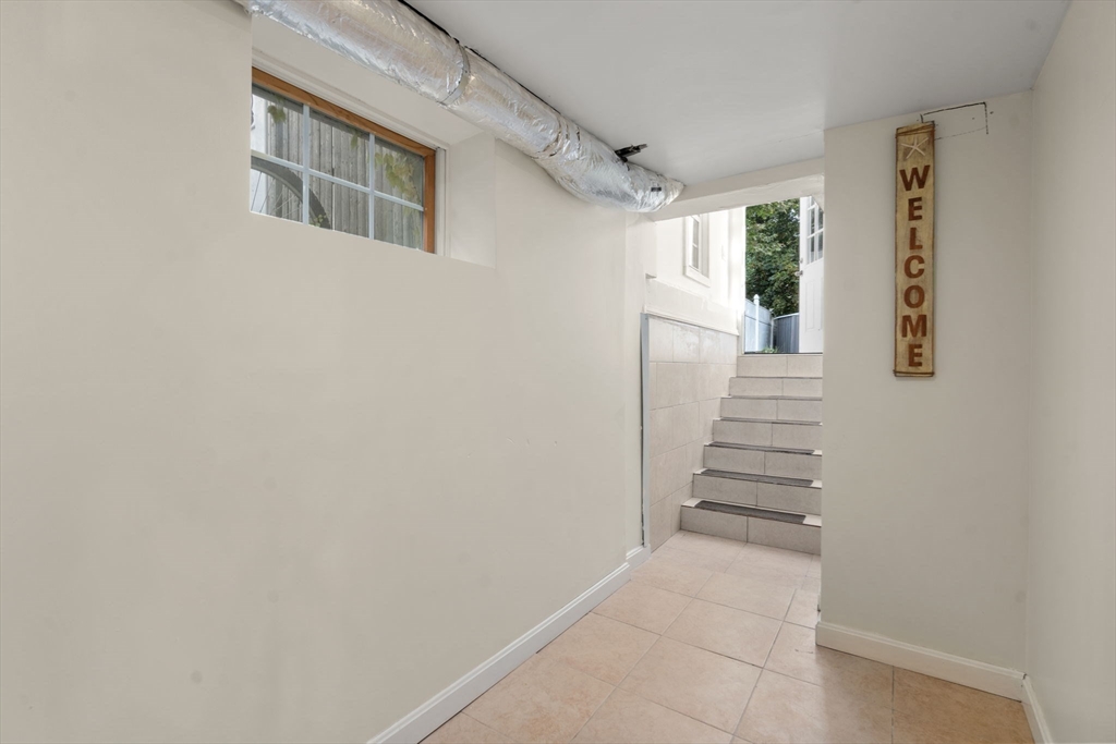 9 Marshall Street Winthrop, MA 02152 - Photo 18 of 34 a view of a hallway with wooden floor and staircase