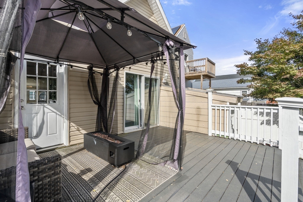 9 Marshall Street Winthrop, MA 02152 - Photo 25 of 34 a view of a deck with wooden floor and roof with a garden view