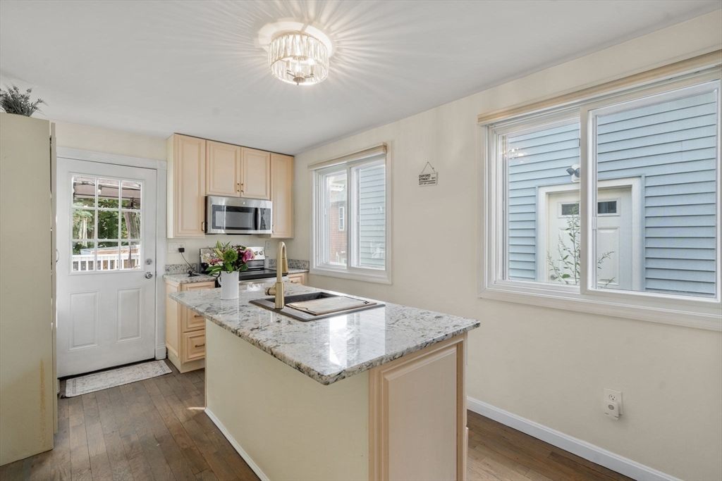 9 Marshall Street Winthrop, MA 02152 - Photo 7 of 34 a kitchen with stainless steel appliances granite countertop a sink stove and cabinets