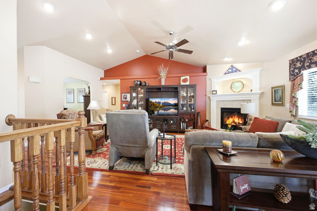776 Flint Street Layton, UT 84041 - Photo 8 of 41 Living area featuring vaulted ceilings, wood-finish flooring, a fireplace with a white mantel, recessed lighting, and a ceiling fan