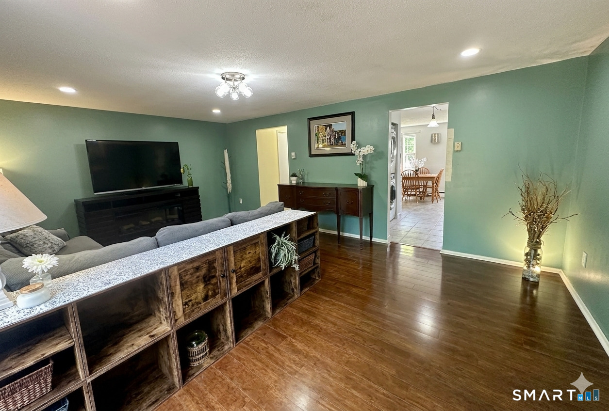 2 Lakeside Drive, Unit M Ledyard, CT 06339 - Photo 11 of 38 a view of living room with furniture flat screen tv and wooden floor