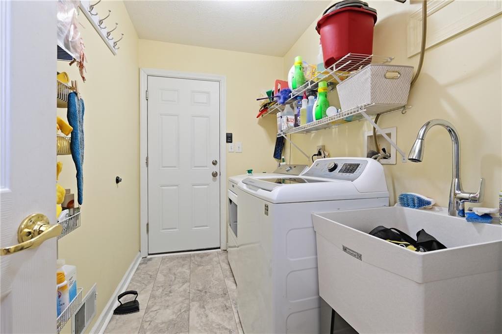 106 Pony Drive Freedom, PA 15042 - Photo 23 of 30 Main Level Laundry Room With Storage Shelves And Utility Tub