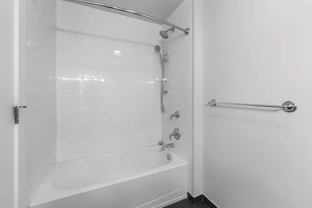 a bathroom with a bathtub and a shower
