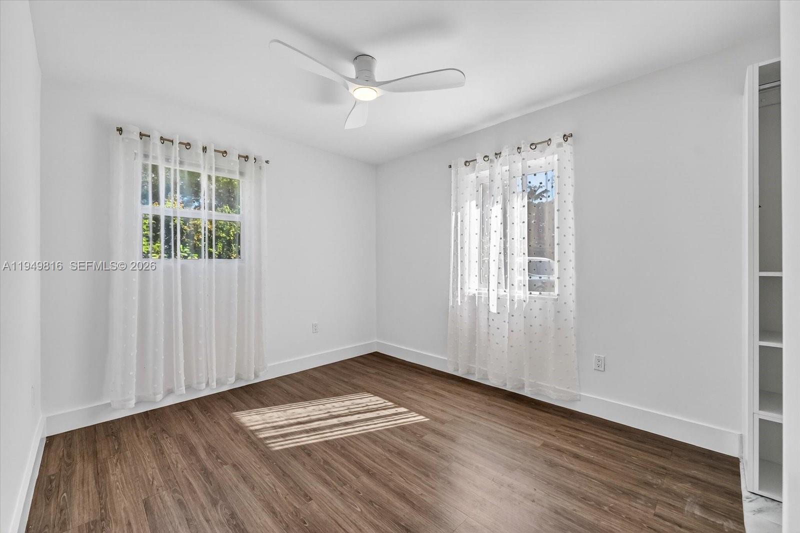 6735 Southwest 51st Street Miami, FL 33155 - Photo 14 of 34 wooden floor in an empty room with a window