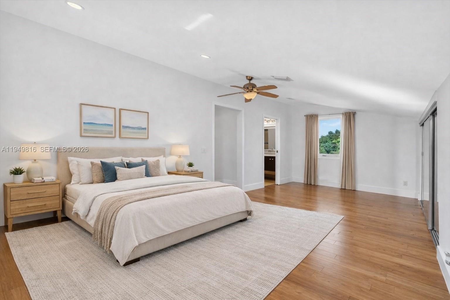 6735 Southwest 51st Street Miami, FL 33155 - Photo 16 of 34 a spacious bedroom with a bed and painting on the wall