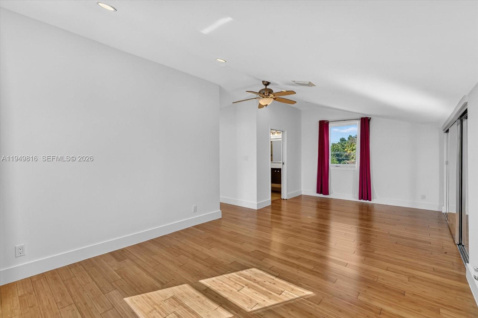 6735 Southwest 51st Street Miami, FL 33155 - Photo 17 of 34 a view of an empty room with window and wooden floor