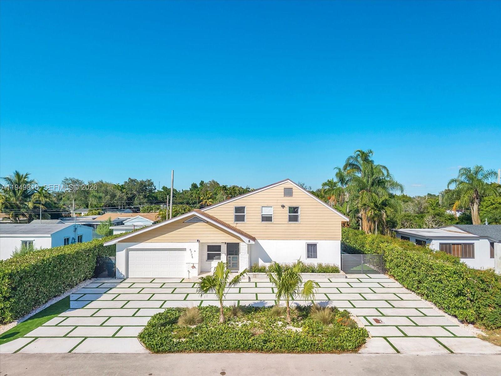 6735 Southwest 51st Street Miami, FL 33155 - Photo 2 of 34 a front view of a house with a yard