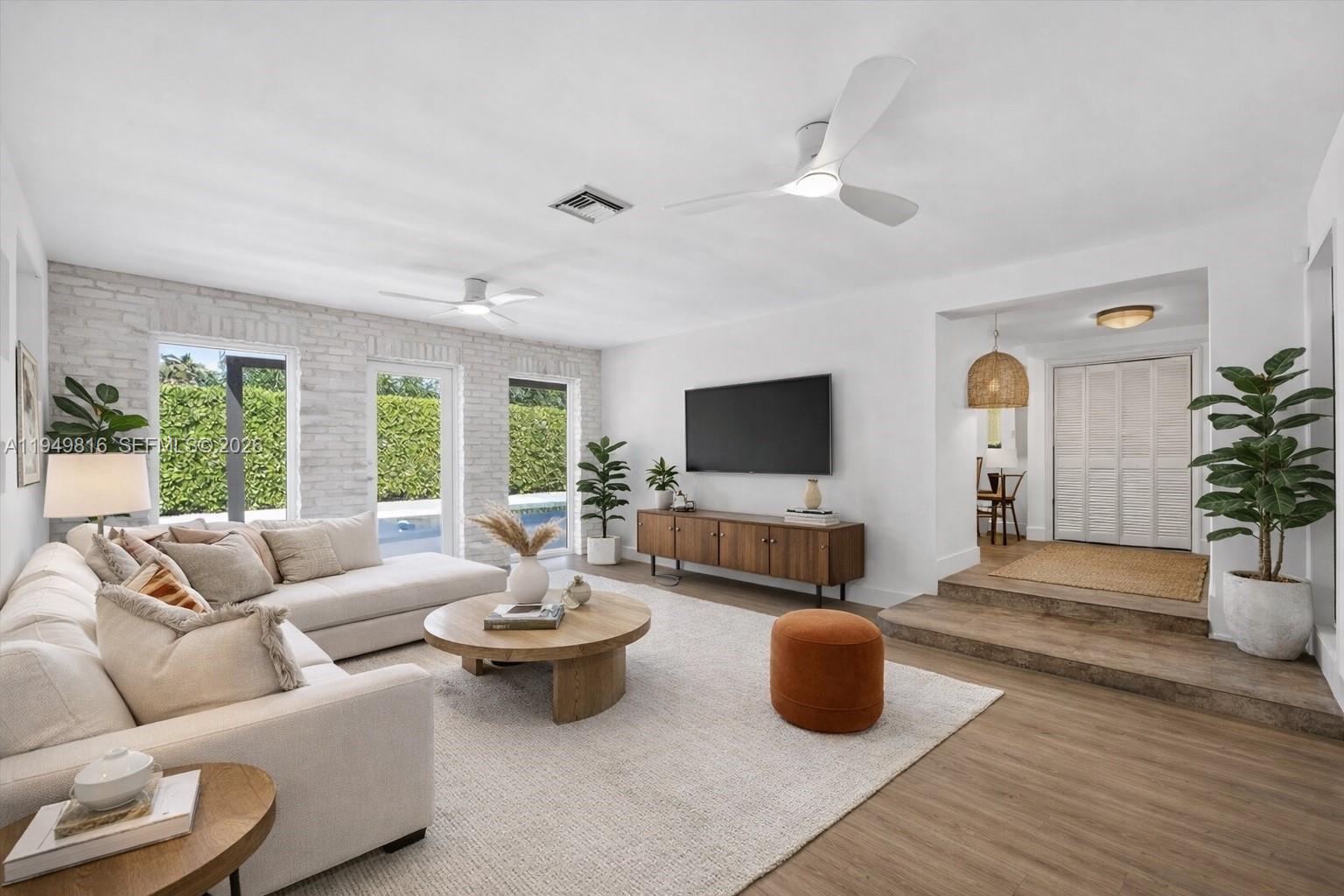 6735 Southwest 51st Street Miami, FL 33155 - Photo 3 of 34 a living room with furniture and a flat screen tv