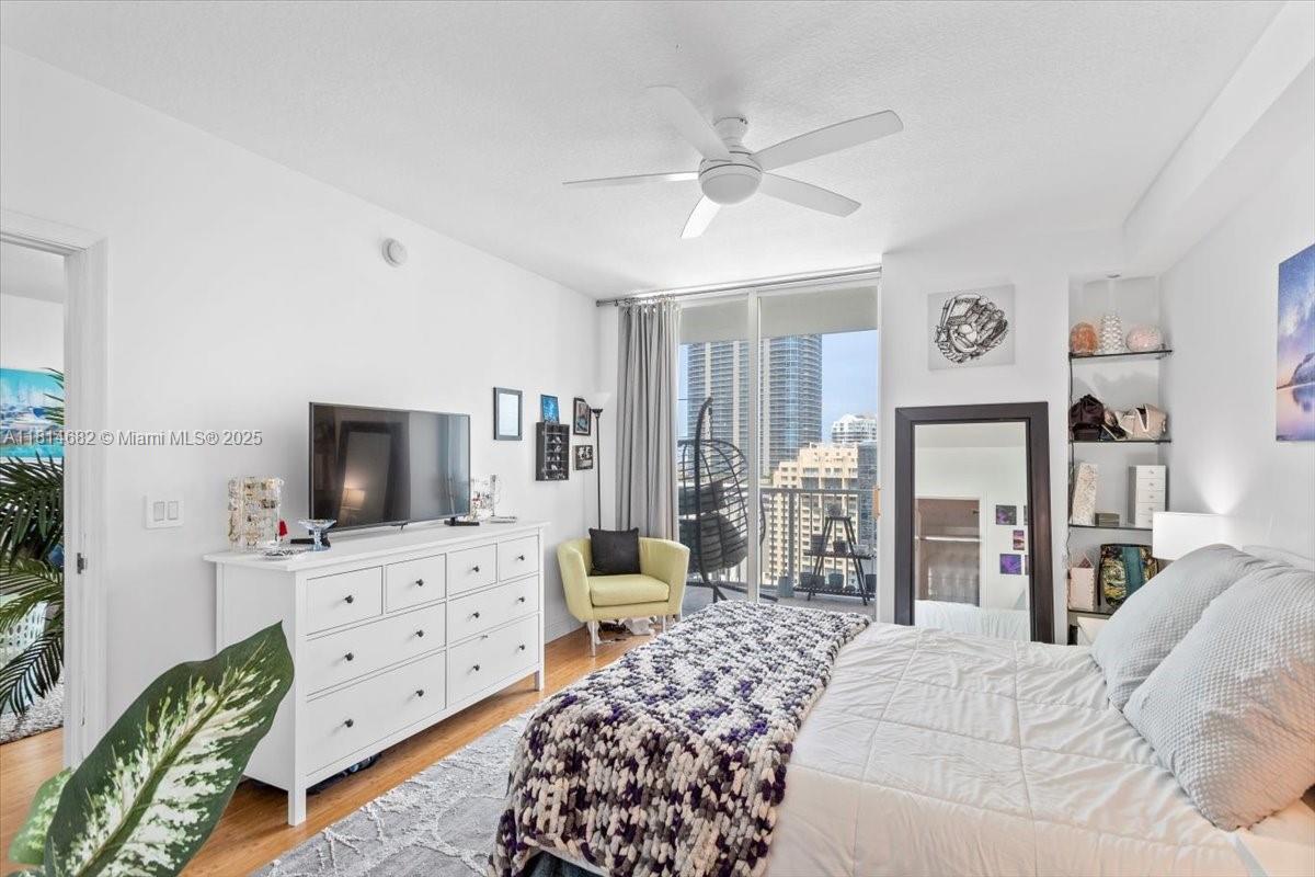 1250 South Miami Avenue, Unit 2208 Miami, FL 33130 - Photo 12 of 28 a bedroom with furniture a flat screen tv and a fireplace