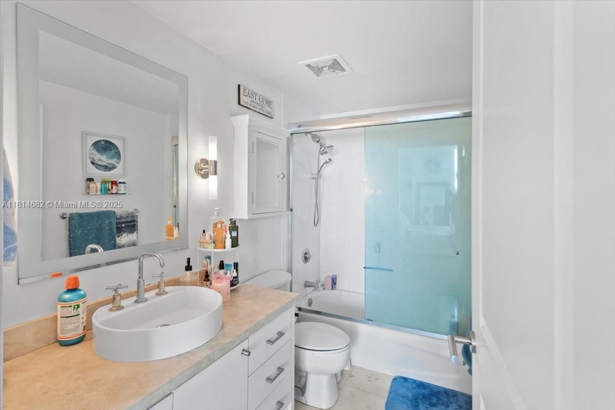 1250 South Miami Avenue, Unit 2208 Miami, FL 33130 - Photo 14 of 28 a bathroom with a sink mirror toilet and shower