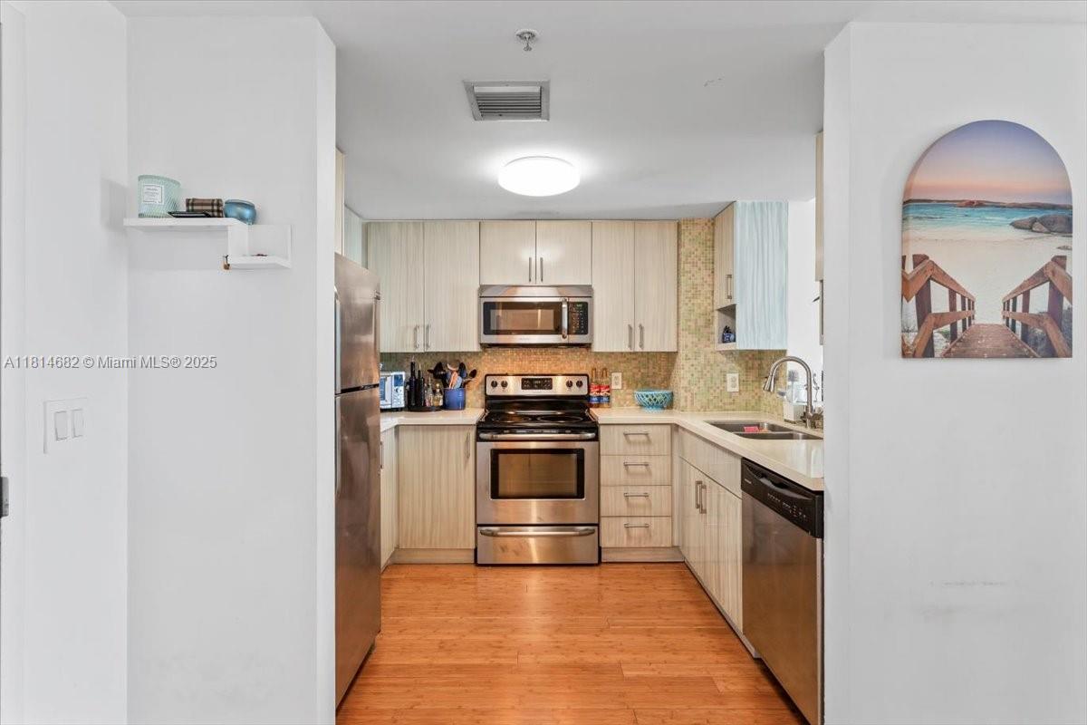 1250 South Miami Avenue, Unit 2208 Miami, FL 33130 - Photo 5 of 28 a kitchen with stainless steel appliances granite countertop a stove top oven a sink and dishwasher