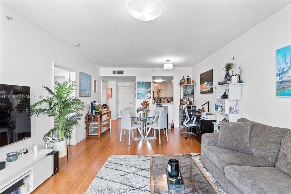 1250 South Miami Avenue, Unit 2208 Miami, FL 33130 - Photo 10 of 28 a living room with furniture potted plant and a flat screen tv