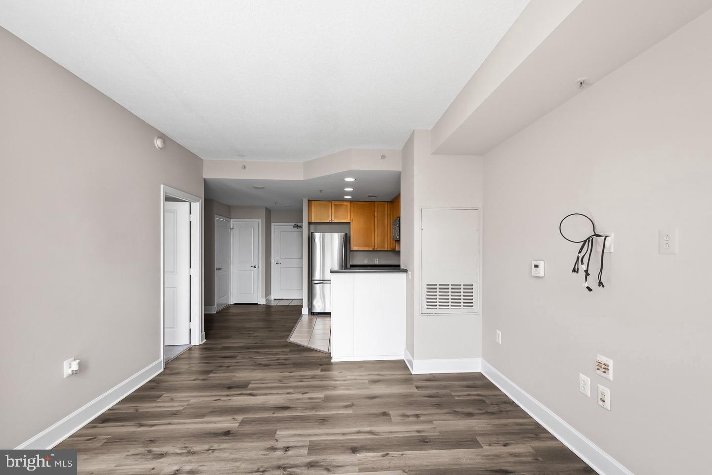 3600 South Glebe Road, Unit 330W Arlington, VA 22202 - Photo 18 of 35 a view of a hallway with wooden floor and a kitchen