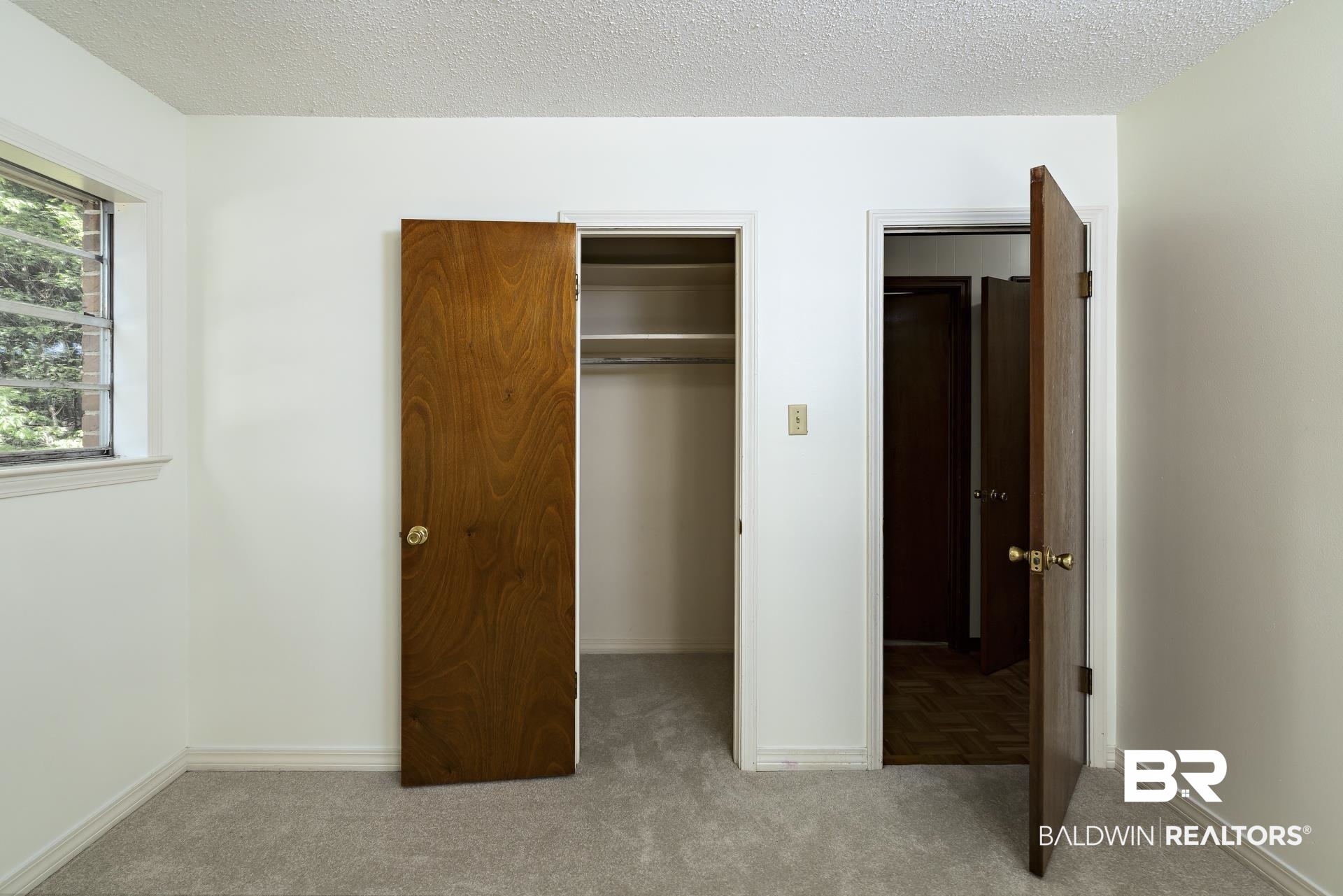 707 Johnson Avenue Fairhope, AL 36532 - Photo 32 of 38 Unfurnished bedroom featuring a walk in closet, a closet, baseboards, and carpet