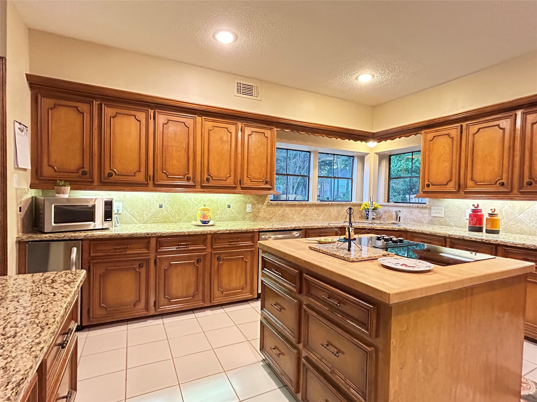 9547 Enstone Circle Spring, TX 77379 - Photo 12 of 45 a kitchen with stainless steel appliances granite countertop a stove sink and cabinets